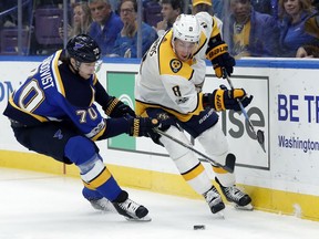 Centre Kyle Turris, right, seen here trying to protect the puck from the Blues' Oskar Sundqvist, signed a six-year contract extension with the Predators immediately after the trade from the Senators.