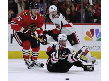 The Senators' Magnus Paajarvi, right, battles for the puck against Chicago's Artem Anisimov.