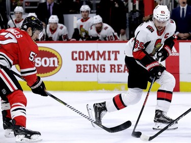 Ottawa Senators defenceman Erik Karlsson controls the puck against Tommy Wingels.