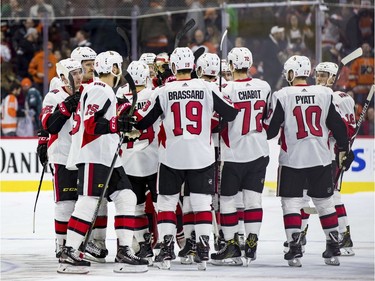 Senators players celebrate the 4-3 win after the shootout against the Flyers.