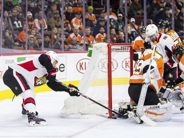 The Senators' Derick Brassard slips the puck past the Flyers' Alex Lyon in the first period.