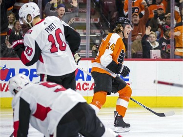The Philadelphia Flyers' Sean Couturier, centre, celebrates after scoring a goal during the second period.