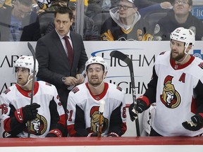 Ottawa Senators coach Guy Boucher stands behind Colin White (36), Mark Stone (61) and Zack Smith (15) during the first period of the team's NHL hockey game against the Pittsburgh Penguins in Pittsburgh, Tuesday, Feb. 13, 2018. The Penguins won 6-3.