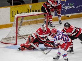 67’s Oliver Tremblay makes a save on Kitchener Rangers’ Adam Mascherin on Sunday. (Valerie Wutti, Blitzen Photography)