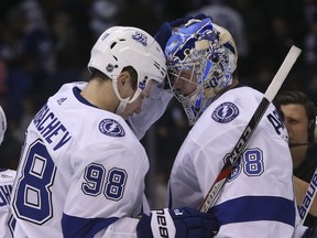 Tampa Bay Lightning D Mikhail Sergachev (98) congratulates his goalie Andrei Vasilevskiy (88) on the 2-0 shutout  in Toronto on Jan. 3, 2018. (JACK BOLAND/Toronto Sun)