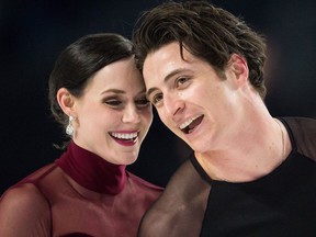 Tessa Virtue, left, and Scott Moir skate off the ice after performing their free dance during the senior ice dance competition at the Canadian Figure Skating Championships in Vancouver on Jan. 13, 2018