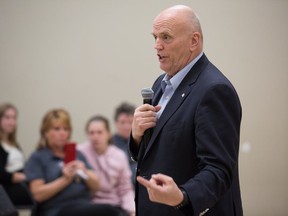 Senator Vern White talks to a meeting at the Kanata Rec Centre. The former chief has waded into the recent debates about policing in Ottawa.