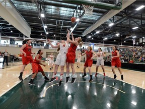 Nicole Gilmore of the Ravens tries to block a shot by Laura Grabe of the Dinos during Thursday's first-round game in Regina. Arthur Ward/Arthur Images