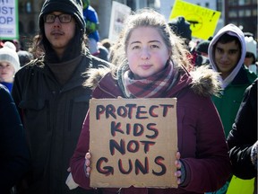 March For Our Lives Ottawa started on Parliament Hill Saturday March 24, 2018, making its way over to Major's Hill Park. People of Ottawa took to the streets joining with others all over North America to demand lives and safety become a priority and to end gun violence and mass shootings in schools. Lisa Maranta stands on Parliament Hill with a Protect Kids Not Guns sign.