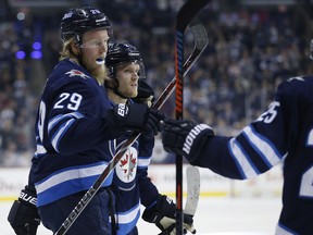 Winnipeg Jets' Patrik Laine celebrates his goal with teammates on Friday. (THE CANADIAN PRESS)