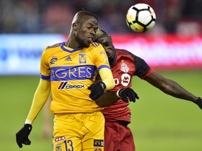 Toronto FC defender Chris Mavinga and UANL Tigres forward Enner Valencia compete for the ball during Wednesday's game. (THE CANADIAN PRESS)