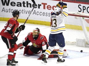 Buffalo Sabres' Nicholas Baptiste celebrates a goal  as the puck bounces in the net behind Ottawa Senators goaltender Craig Anderson during Thursday's game. (THE CANADIAN PRESS)