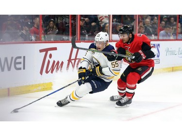 Jim O'Brien (R) of the Ottawa Senators battles against Rasmus Ristolainen.