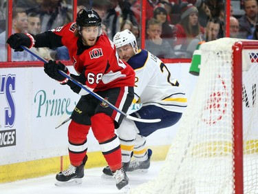 Mike Hoffman of the Ottawa Senators in action behind the net against Johan Larsson.