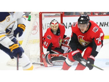 Craig Anderson and Mark Borowiecki (R) of the Ottawa Senators in action against the Buffalo Sabres.
