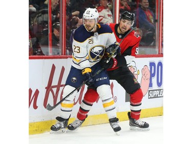 Cody Ceci of the Ottawa Senators battles against Sam Reinhart.