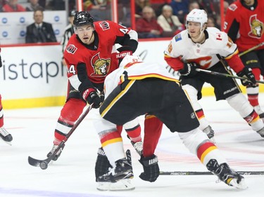 Jean-Gabriel Pageau of the Senators tries to work his way past the Flames' Michael Frolik in the first period. Jean Levac/Postmedia