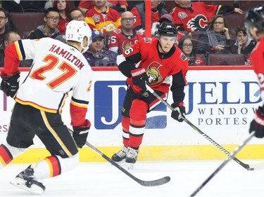 Magnus Paajarvi of the Senators tries to thread the puck by Dougie Hamilton of the Flames to Marian Gaborik during the first period. Jean Levac/Postmedia