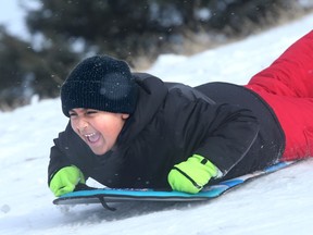 Zain Makani, 6, roars down an icy strip on a hill beside Kanata Rec Centre.