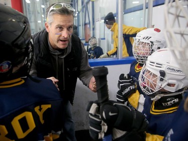 Metcalfe Hornets assistant coach Sean O'Neill keeps up the energy on the bench with his young players.  Julie Oliver/Postmedia