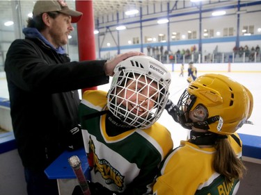 Julia Green of the U-10 Gloucester-Cumberland team gets some high fives and helmet slaps after scoring against the Metcalfe Hornets.  Julie Oliver/Postmedia