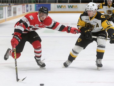 Ottawa's Mitchell Hoelscher (left) keeps Hamilton's Jack Hanley at arm's length while racing towards Hamilton's net during playoff game 3 between the Ottawa 67s and the Hamilton Bulldogs Tuesday (March 27, 2018) at TD Place in Ottawa.