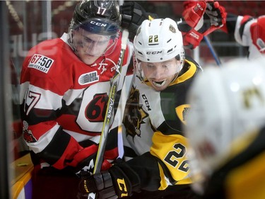 Ottawa's Mitchell Hoelscher (left) battles for the puck in the boards at Hamilton's end during playoff game 3 between the Ottawa 67s and the Hamilton Bulldogs Tuesday (March 27, 2018) at TD Place in Ottawa.