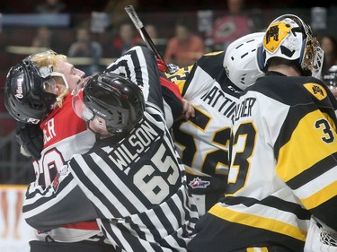 Ottawa's Tye Felhaber (left) fights through a ref to get to Nicolas Mattinen as tensions mounted at the end of the first period with Hamilton up 1-0.  The Ottawa 67s and the Hamilton Bulldogs Tuesday (March 27, 2018) at TD Place in Ottawa.