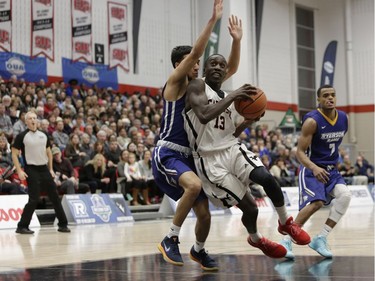 Carleton's Munis Tutu drives to the basket against the Ryerson defence. David Kawai/Postmedia