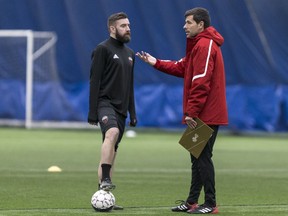 Fury FC head coach Nikola Popovic speaks with defender Colin Falvey during a workout earlier in training camp. Errol McGihon/Postmedia