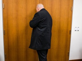 An OPP officer with Premier Kathleen Wynne's security detail keep his foot on the door to the entrance of the reception area of the mayor’s office while a distraught woman is screaming on Thursday, March 1, 2018. (Ernest Doroszuk/Toronto Sun)