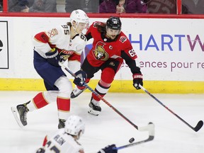 Ottawa Senators defenceman Erik Karlsson tries to stop Florida Panthers centre Henrik Borgstrom during Thursday night’s game at the CTC. (THE CANADIAN PRESS)