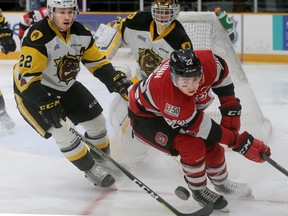 Ottawa 67's Jack Quinn tries to get the puck under control around the Hamilton Bulldogs' net during Wednesday's game. (JULIE OLIVER/Postmedia Network)