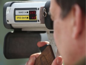 A police officer with a radar gun.