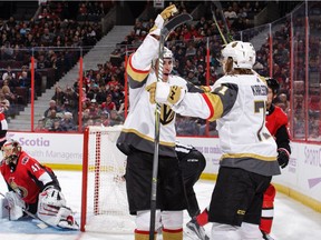 Golden Knights teammate Reilly Smith, left, helps William Karlsson celebrate a third-period goal against the Senators in a game in Ottawa on Nov.