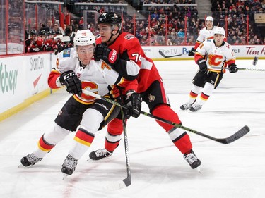 Mark Borowiecki (74) of the Senators battles for position against Micheal Ferland of the Flames in the first period.