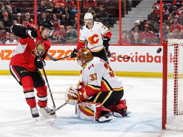 Ryan Dzingel of the Senators has his shot graze the post behind Flames netminder David Rittich in the second period.