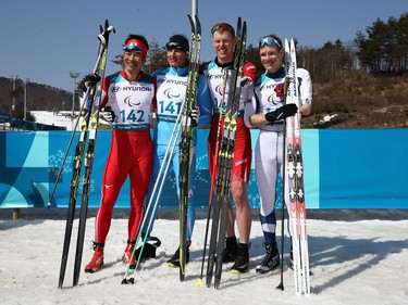 Posing for a photo following the men's cross-country ski 1.5-kilometre sprint race on Wednesday are, left to right, gold medallist Alexandr Kolyadin of Kazakhstan, silver medallist Yoshihiro Nitta of Japan, bronze medallist Mark Arendz of Canada and Ilkka Tuomisto of Finland.