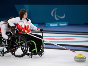 Canada's Marie Wright throws a stone during the wheelchair curling bronze-medal game against South Korea on Saturday in Pyeongchang.