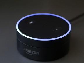 This Wednesday, March 2, 2016 photo shows an Echo Dot in San Francisco. Amazon.com is introducing two devices, the Amazon Tap and Echo Dot, that are designed to amplify the role that its voice-controlled assistant Alexa plays in people's homes and lives.
