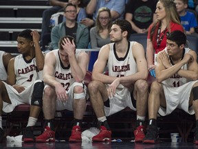 Members of the Carleton Ravens react on the bench in the final seconds of their loss to the Ryerson Rams. THE CANADIAN PRESS/Darren Calabrese