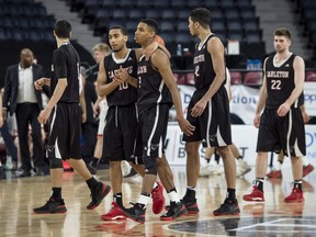 Members of the Carleton Ravens react after defeating the McGill Redmen in the bronze medal game of the U Sports men's basketball national championship in Halifax on Sunday, March 11, 2018. THE CANADIAN PRESS/Darren Calabrese