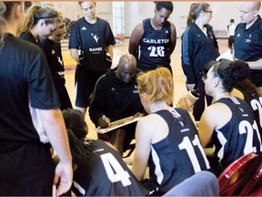 Carleton head coach Taffe Charles huddles with Ravens players during a timeout in a game earlier this season. The Ravens head into nationals after an undefeated season and conference playoff run. THE CANADIAN PRESS/Carleton University