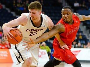 Carleton Ravens' Mitch Wood fights for possession against Acadia on Thursday, March 8, 2018, in Halifax.
