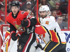 Matt Duchene of the Ottawa Senators (left) battles with Mark Giordano of the Calgary Flames in Ottawa, March 9, 2018. (Jean Levac/Postmedia)