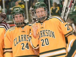 Ottawa's Katelyn Fournier (24) and Ingleside's Kristy Pidgeon (20) have reason to smile as the Clarkson women's hockey team celebrates its conference championship-clinching 3-0 victory against Colgate on March 4. Steve Jacobs/Clarkson University