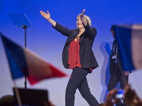 Far-right leader and candidate for the 2017 French presidential election Marine Le Pen acknowledges applauses as she arrives on stage for a meeting in Marseille, southern France, Wednesday, April 19, 2017.