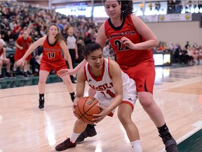 The Carleton Ravens' Heather Lindsay, right, applies defensive pressure to the McGill Martlets' Geraldine Cabillo-Abante (11) during Saturday's U Sports 2018 Women's National Basketball Championship Semi-Final on March 10, 2018, in Regina. (Arthur Ward/Arthur Images)