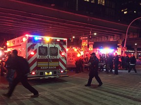 First responders carry a person to an ambulance after a helicopter crashed into the East River along New York on Sunday, March 11, 2018. (AP Photo/Shelly Acoca)