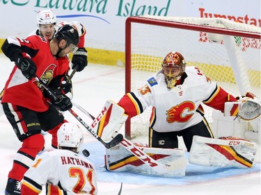 Flames netminder David Rittich blocks a shot by Senators winger Marian Gaborik during second-period action.